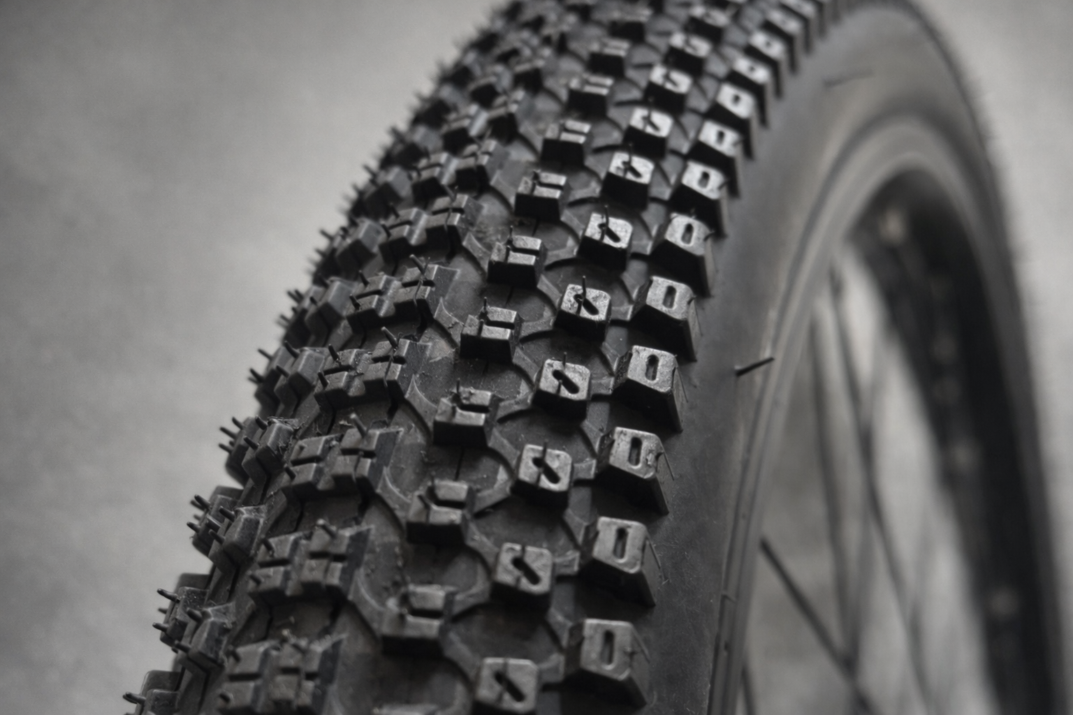 Close-up of BlackCat 27.5x2.35 bicycle tyre tread pattern showing aggressive grip blocks
